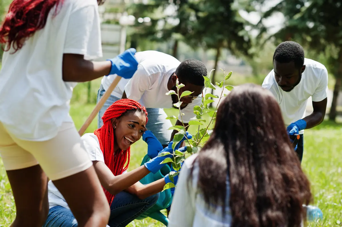 Young volunteers planting a tree
